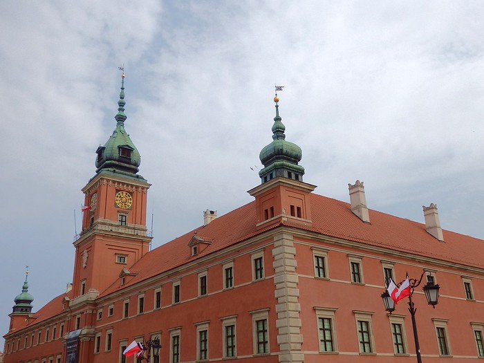 The Royal Castle in Warsaw, Poland from the outside showcasing its distinct architectural details from a wide angle vantage point