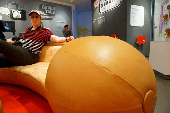 The sausage sofa inside Berlin's Currywurst Museum in Germany as being enjoyed by a lounging lizard aka Nomadic Samuel