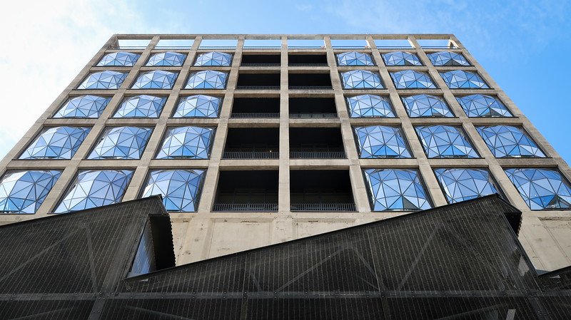 Modern industrial-style facade of The Silo Hotel in Cape Town, featuring geometric glass windows set in a historic grain silo building at the V&A Waterfront