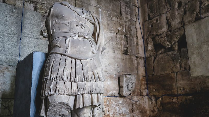 The small museum inside the Temple of Augustus showing ancient sculptures 