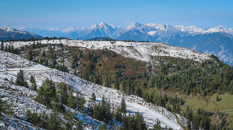 The Tyrolean Alps from a high vantage point view featuring snow and forest views and mountains totally snow capped in Austria 