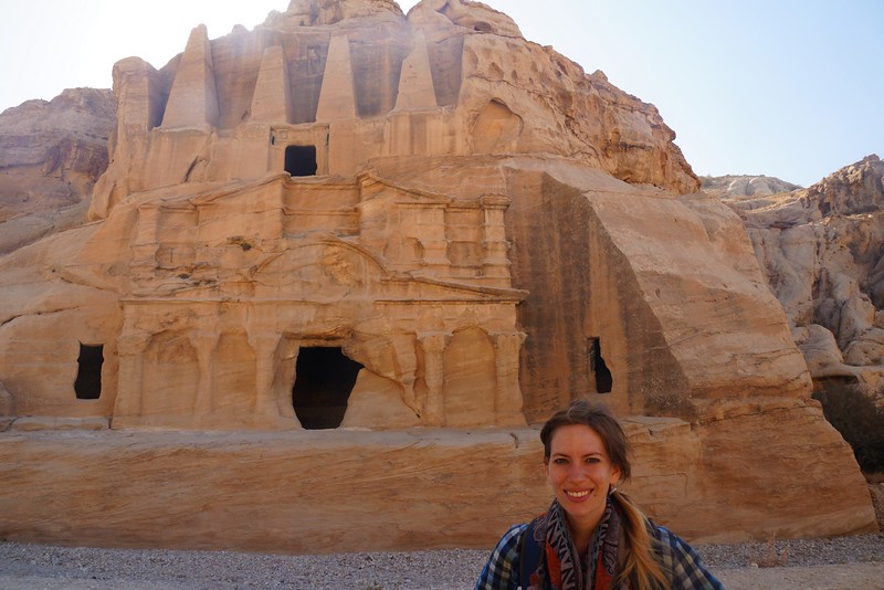 The walk towards Petra begins in Jordan with That Backpacker Audrey Bergner all smiles in the foreground and the lost city surprising in the background