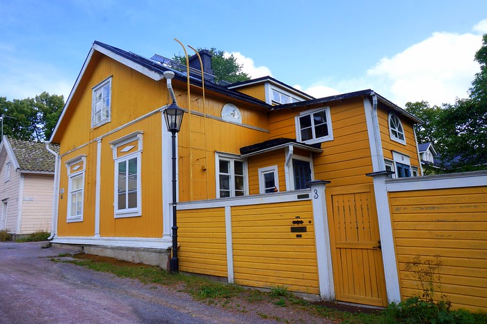 The wooden buildings of Ekenäs painted in bright colours such as yellow in Finland 
