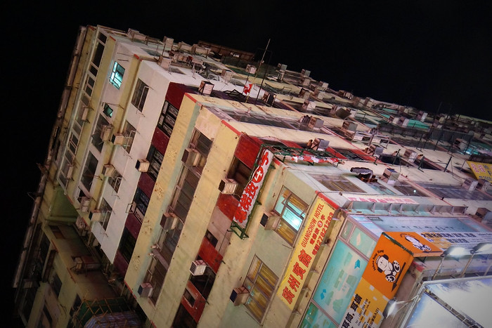 Touring Hong Kong at night with views of an older building 