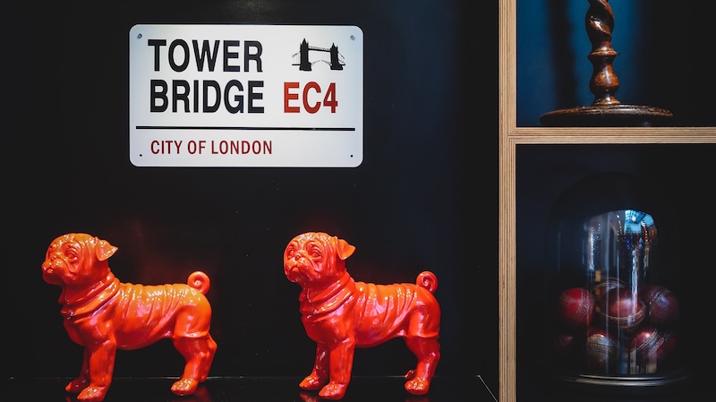 Tower Bridge city of London and two dog figurines art display in London, England Tower Bridge city of London and two dog figurines art display in London, England