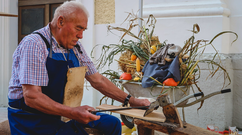 Traditional craft demonstrations take place in Reith im Alpbachtal with an elderly Austrian man perfecting his craft in front of the public eye