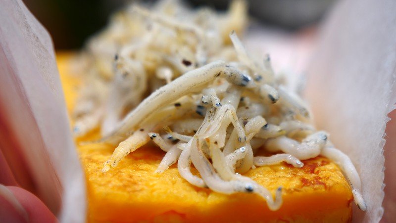 Trying omelette with whitebait in Kamakura - a popular street food snack on your day trip from Tokyo, Japan Trying omelette with whitebait in Kamakura - a popular street food snack on your day trip from Tokyo, Japan