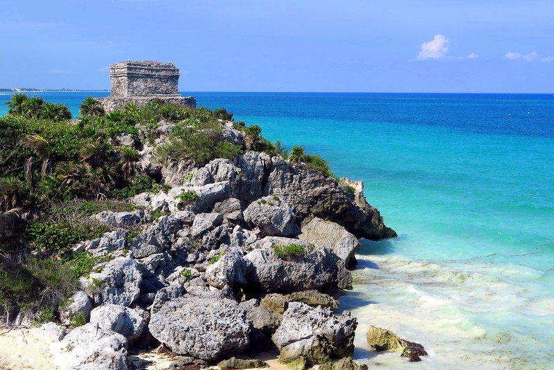 Ancient Mayan ruins of Tulum perched on a cliff overlooking the turquoise Caribbean Sea near Playa del Carmen, Mexico
