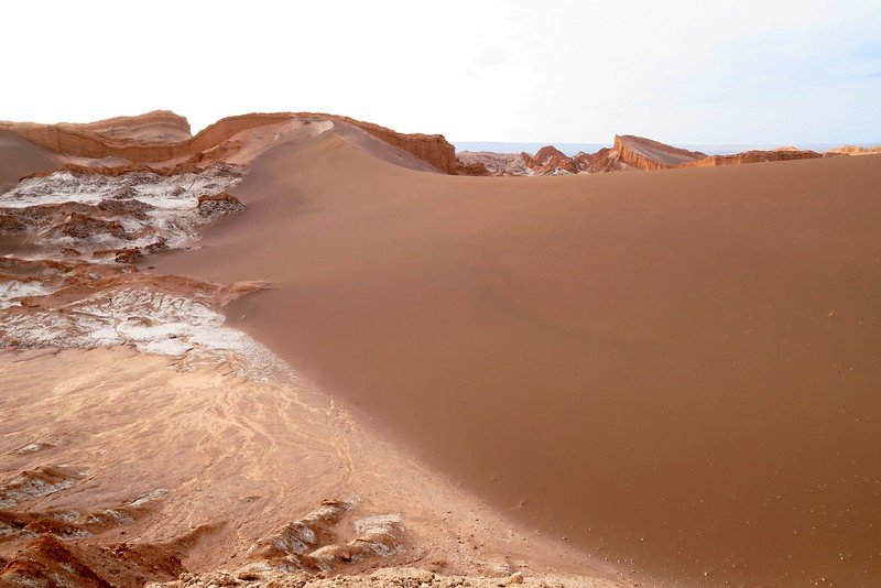 Towering sand dune in Valle de la Luna, Atacama Desert, Chile, surrounded by dramatic red rock formations