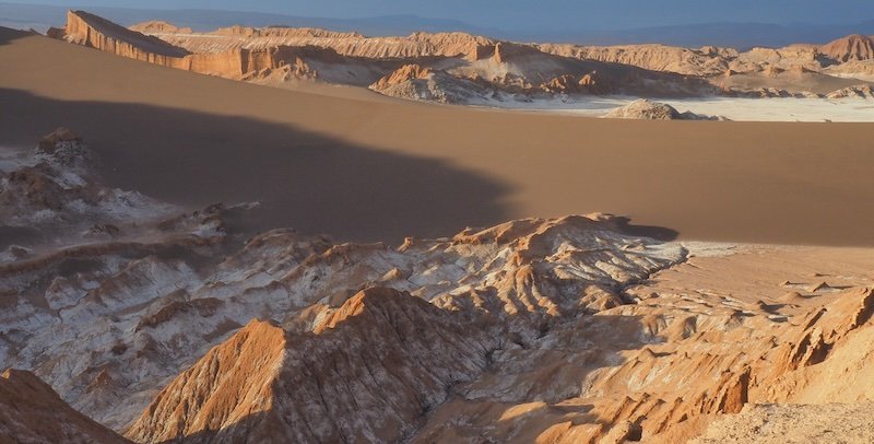 Diverse geological formations of the Valley of the Moon in Chile’s Atacama Desert, featuring sand dunes, salt flats, and rugged rock formations at sunset Diverse geological formations of the Valley of the Moon in Chile’s Atacama Desert, featuring sand dunes, salt flats, and rugged rock formations at sunset
