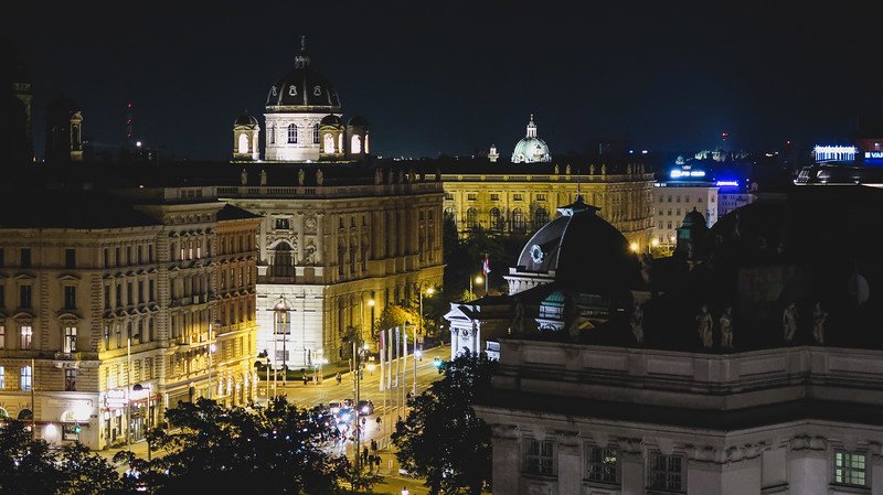 Illuminated domes and grand historic buildings of Vienna glowing at night, as seen from the rooftop Dachboden Bar at the 25hours Hotel Illuminated domes and grand historic buildings of Vienna glowing at night, as seen from the rooftop Dachboden Bar at the 25hours Hotel