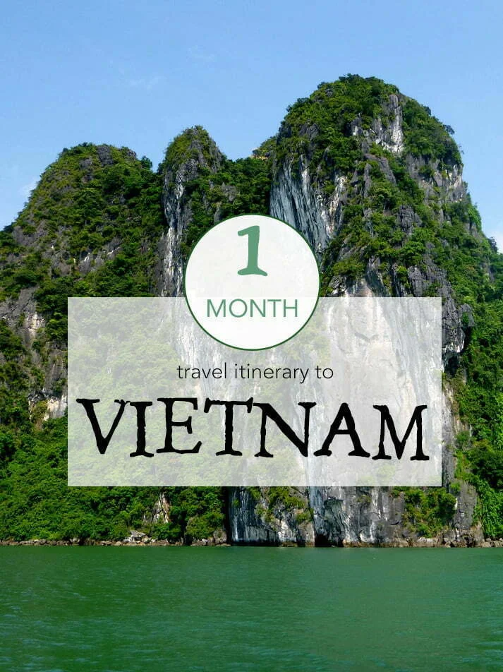 Dramatic limestone karst cliffs rising above emerald waters in Halong Bay, overlaid with text reading “1 Month Travel Itinerary to Vietnam,” highlighting a month-long adventure route across the country