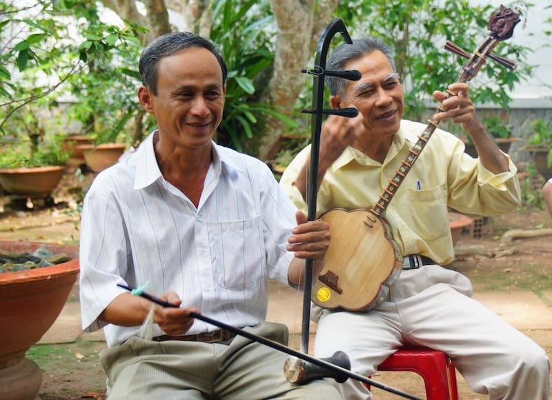 Vietnamese musicians playing traditional music on our Mekong Delta Tour in Vietnam Vietnamese musicians playing traditional music on our Mekong Delta Tour in Vietnam