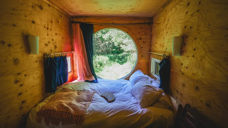 View of our bedroom with large circular window in this unique tiny home in Toronto View of our bedroom with large circular window in this unique tiny home in Toronto