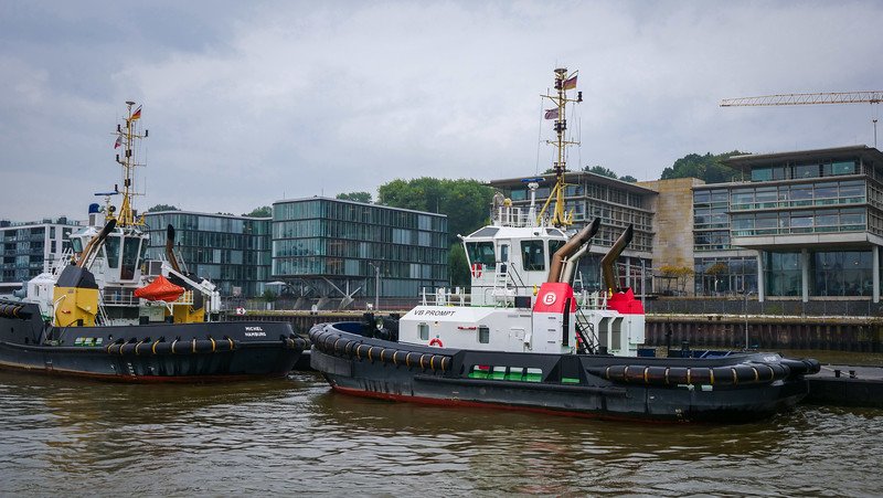 Views during the 1-hour boat tour of Hamburg with modern buildings and modern tug boats in Germany Views during the 1-hour boat tour of Hamburg with modern buildings and modern tug boats in Germany