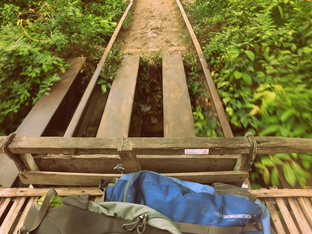 Views from the Bamboo Train of the track and scenery in Battambang, Cambodia with our backpacks stored right beside us