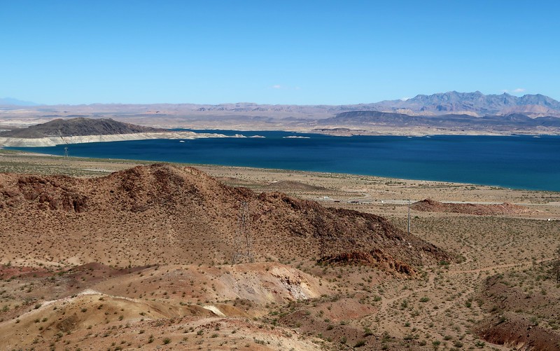 Views of Lake Mead in Nevada from a high vantage point with mountain foreground and lake middle ground and mountain backdrop