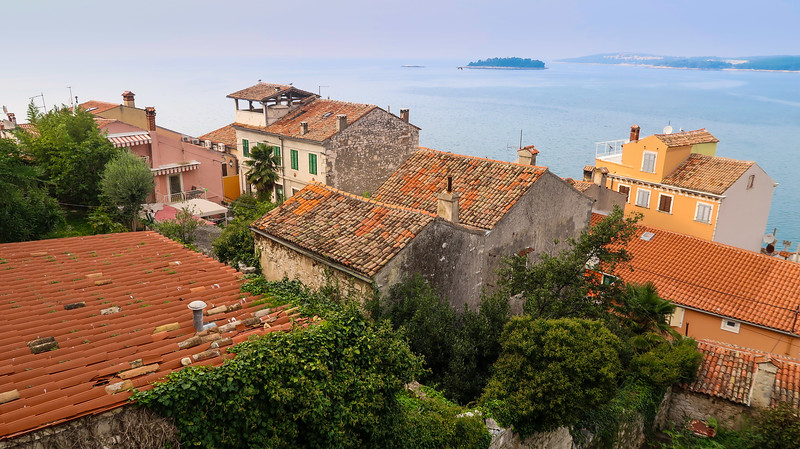 Views of Rovinj from St. Euphemia's Church with distinct architectural and rooftop views overlooking the calm waters in Croatia 
