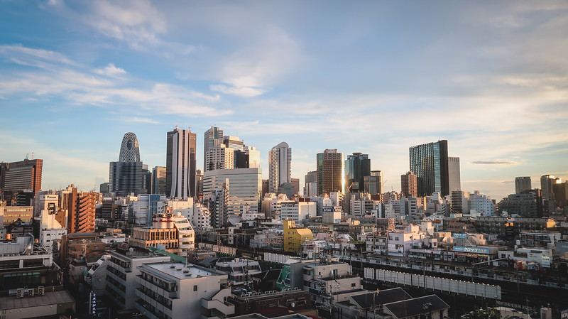Views of Shinjuku, Tokyo from the common area in the 9 Hours capsule hotel with a clear skyline of tall buildings Views of Shinjuku, Tokyo from the common area in the 9 Hours capsule hotel with a clear skyline of tall buildings