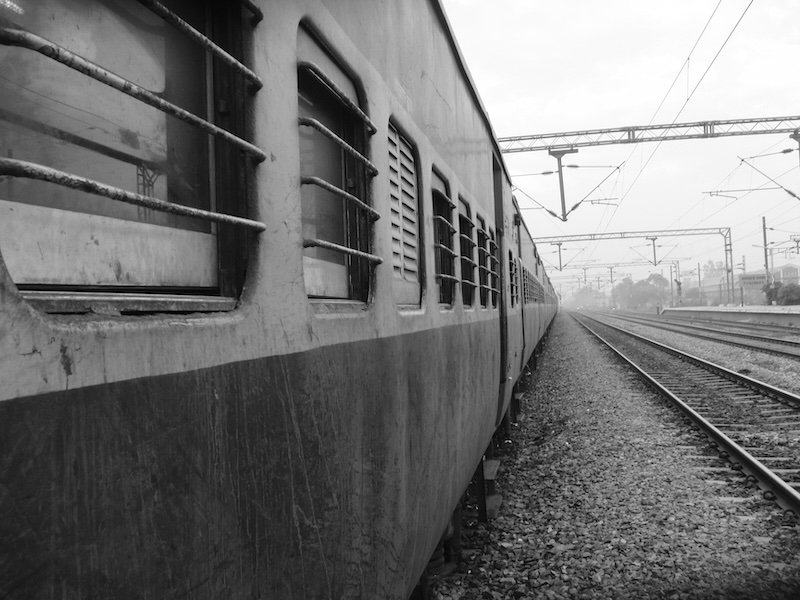 Views of the Indian Train from outside of the window on the tracks greyscale 
