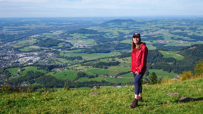 Views of the valley from atop Gaisberg, Austria with a posing That Backpacker Audrey Bergner dressed for the hiking occasion 
