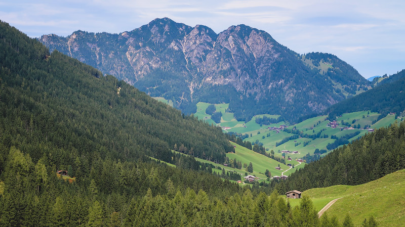 Views on our e-biking tour in Tyrol featuring dramatic valleys, densely forested areas and rugged mountain backdrops in Austria 