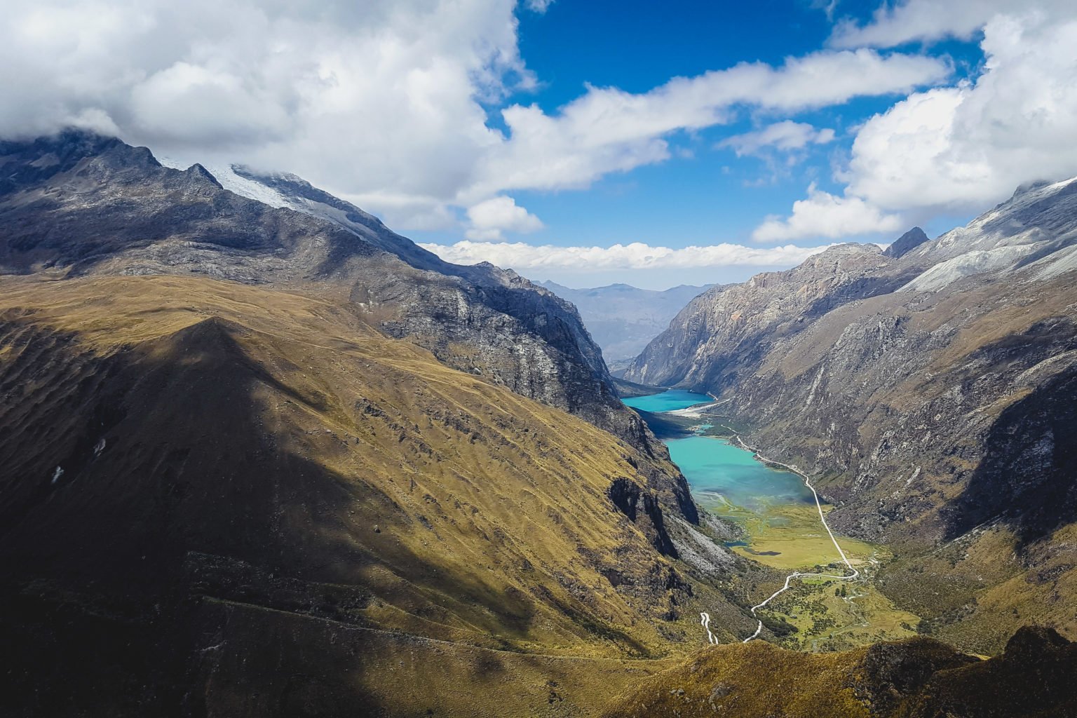 Views on the drive to start the Santa Cruz Trek from Huaraz featuring rugged mountain landscapes and turquoise waters 