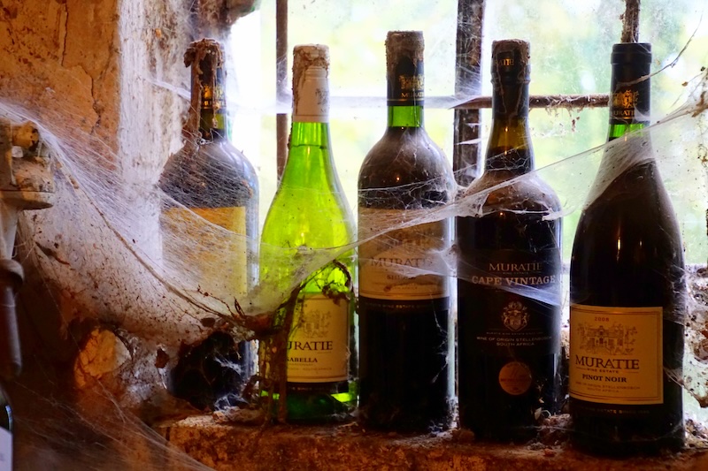 Vintage Muratie bottles of wine covered in cobwebs in Stellenbosch, South Africa  