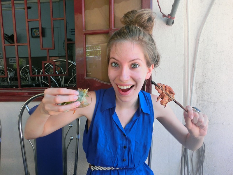 Visit Vietnam for the food: spring rolls and grilled meat. That Backpacker Audrey Bergner eating at Bale Well in Hoi An, Vietnam