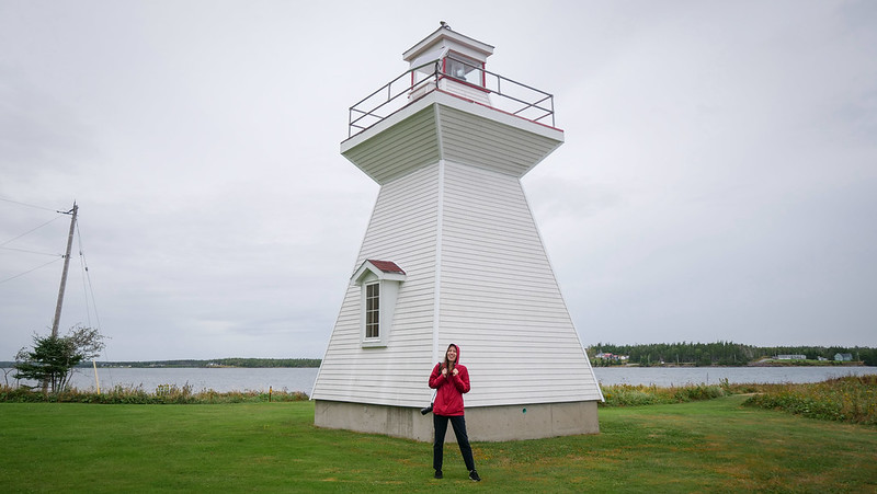 Visiting Grandique Point Lighthouse at Lennox Passage Provincial Park on Isle Madame on Cape Breton Island with Audrey Bergner That Backpacker posing