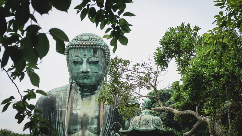 Visiting Kotoku-in on our day trip from Tokyo to Kamakura with imposing buddha statue looming large Visiting Kotoku-in on our day trip from Tokyo to Kamakura with imposing buddha statue looming large