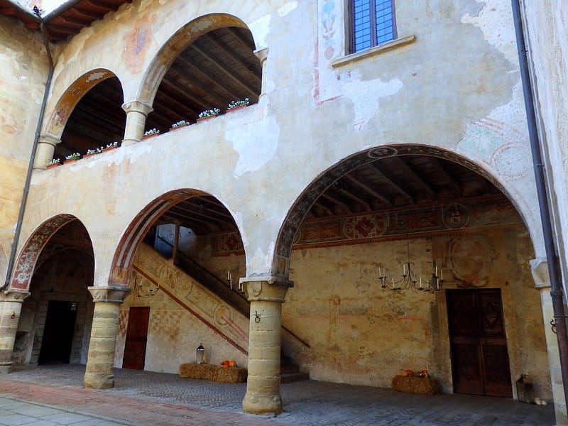 Visiting Malpaga Castle in Bergamo, Italy admiring its distinct architecture