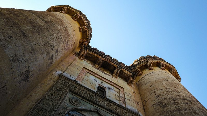 Visiting Mehrangarh Fort with its imposing size and intricate design from a low vantage point looking upwards to twin towers in Jodhpur 