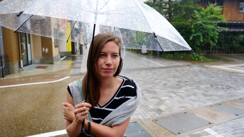 Visiting Takayama, Japan in the summer often means rainy days and the need for an umbrella as displayed by That Backpacker Audrey Bergner out in the rain 