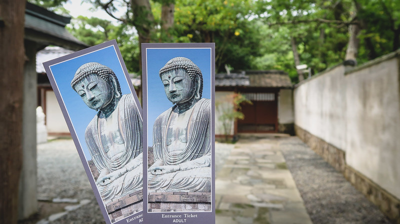 Visiting the Buddha in Kotoku-in, Kamakura entrance tickets held in hand Visiting the Buddha in Kotoku-in, Kamakura entrance tickets held in hand
