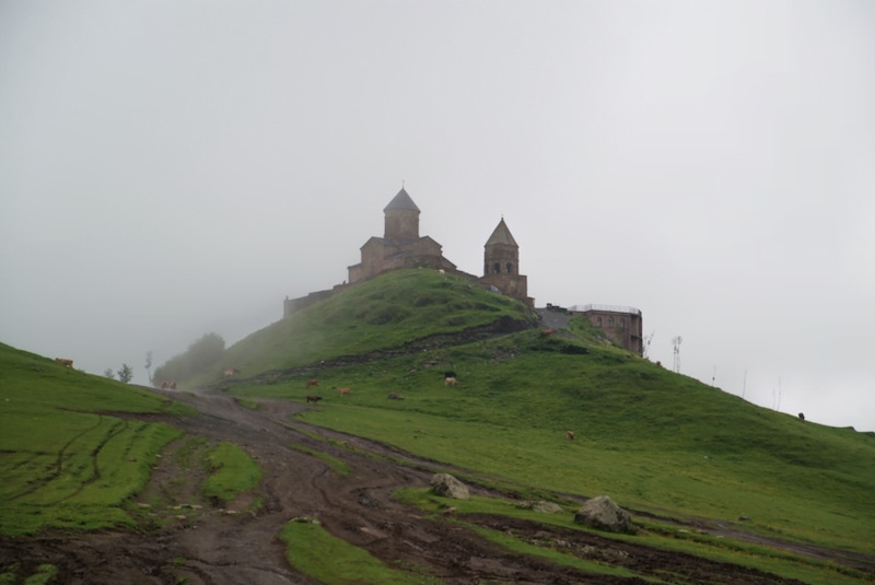 Visiting the Gergeti Trinity Church in Georgia on an atmospheric, overcast and rainy day 