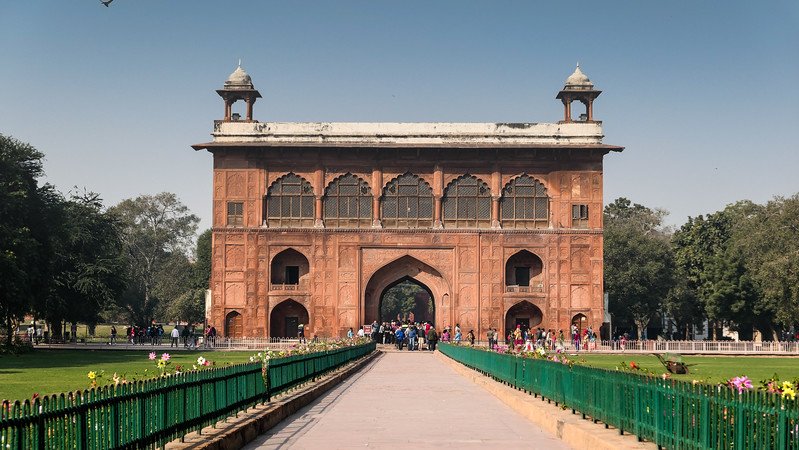 Visiting the Red Fort in Delhi with massive gats and garden complex in India