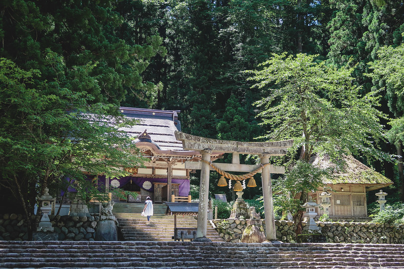 Visiting the Shirakawa Hachiman Shrine in Shirakawa-go, Japan which has a forest backdrop Visiting the Shirakawa Hachiman Shrine in Shirakawa-go, Japan which has a forest backdrop
