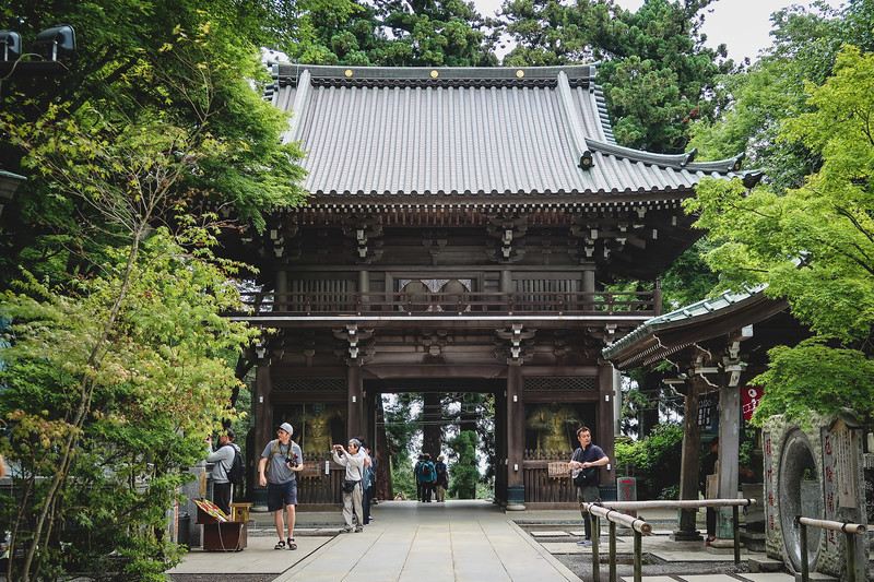 Visiting the temple on Mount Takao on our day trip from Tokyo, Japan with Nomadic Samuel with camera in hand