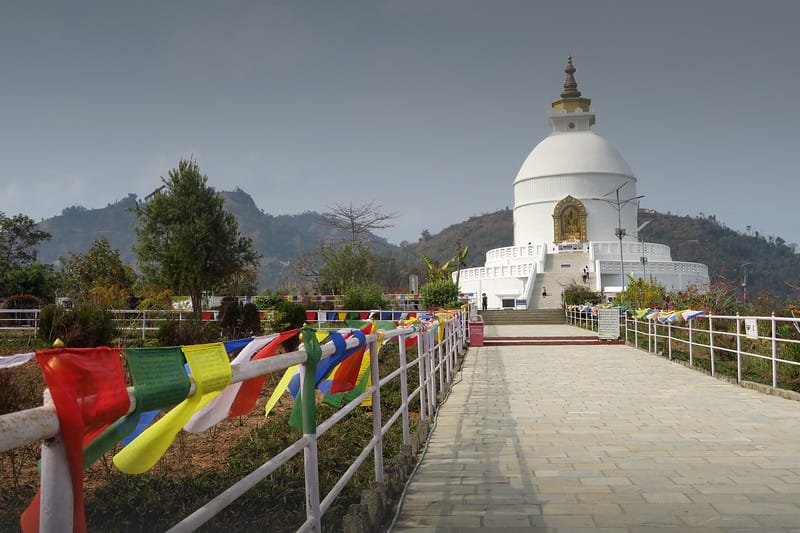Visiting the World Peace Pagoda in Pokhara, Nepal with its distinct prayer flags and white dome
