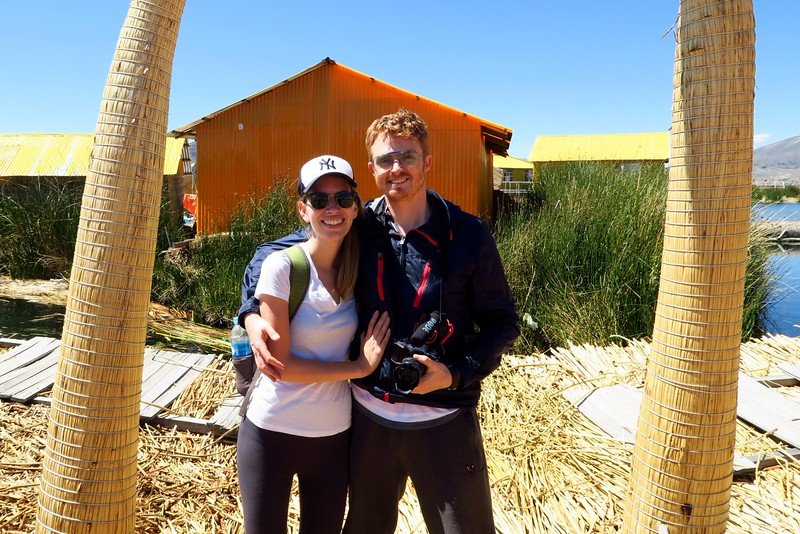 Visiting Uros Islands in Lake Titicaca, Peru are a happy couple Nomadic Samuel and Audrey Bergner That Backpacker 