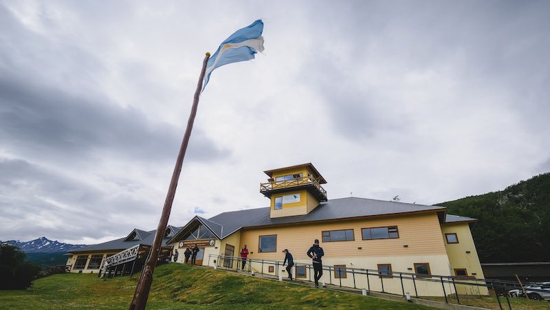 Visitor centre with Argentina flag flapping in the wind at Tierra del Fuego National Park in Ushuaia, Argentina 