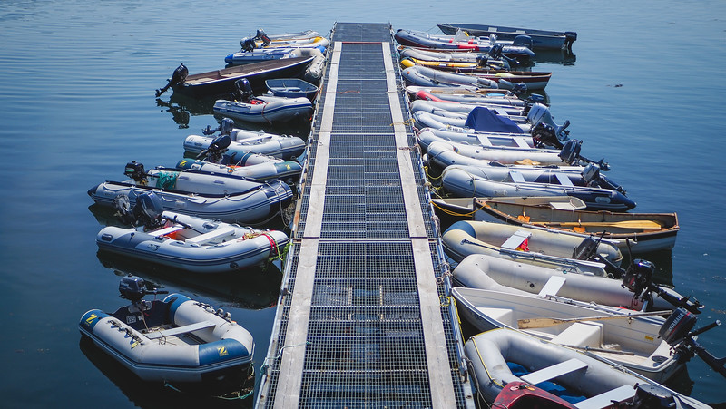 Walking along the waterfront in St. Andrews, New Brunswick with motorized dingy boats lined up along the dock