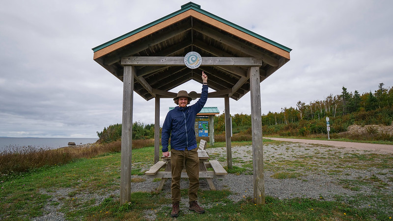 Walking the Celtic Shores Coastal Trail on Cape Breton Island, Nova Scotia with a pointing Nomadic Samuel taking in the rugged beauty 