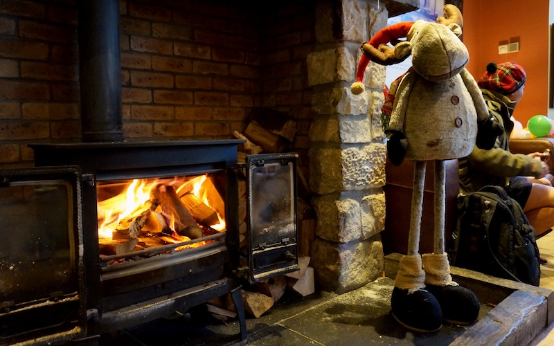Warming up by a fireplace for Hogmanay as New Year's celebration in Edinburgh, Scotland 