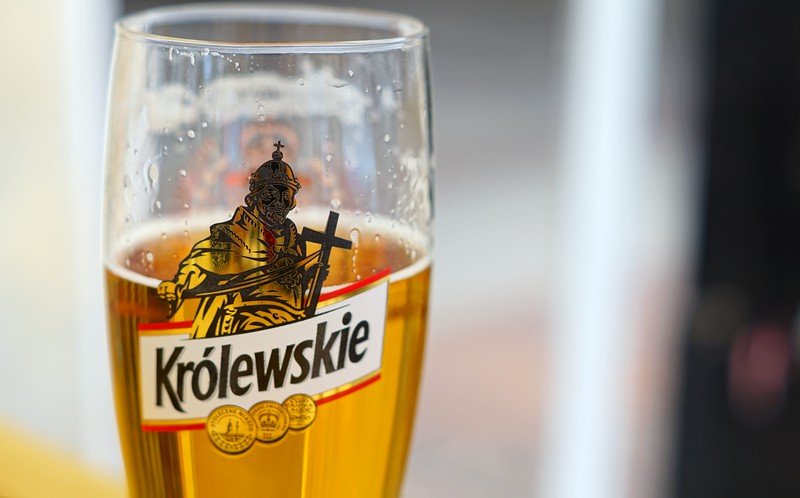 Close-up of a glass of Królewskie beer served at a pub in Warsaw, Poland. Sampling local Polish beers is a must-try experience for foodies exploring the capital city, offering a taste of traditional brewing culture and regional flavors