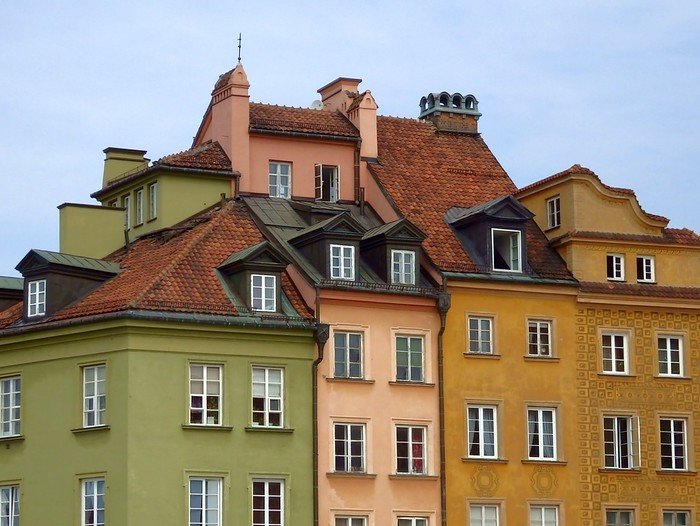 Warsaw's Old Town colorful building in the downtown square featuring green, pink, tan and brown in Poland
