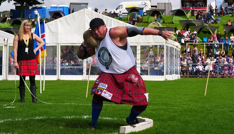 Watching the Heavy Athletics at the Cowal Games with views of the performance field 