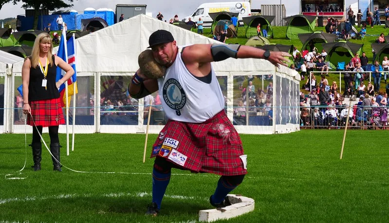 Watching the Heavy Athletics at the Cowal Games with views of the performance field 