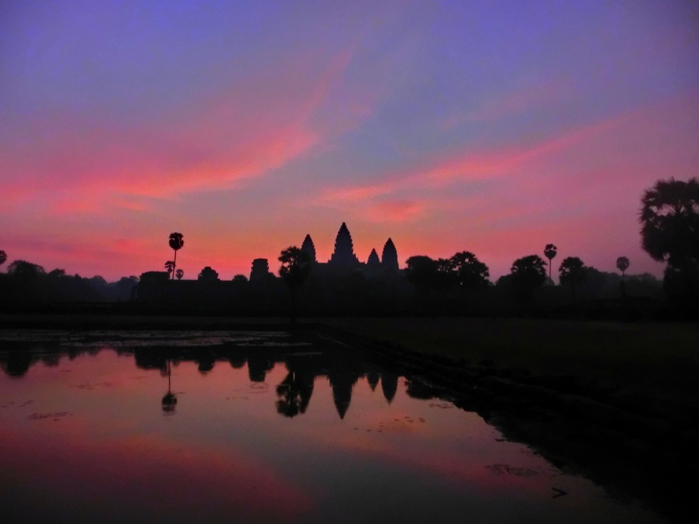 Watching the sunrise over Angkor Wat, Cambodia as we were dazzled by the pink hues and silhouettes and the grandeur of it all in SE Asia